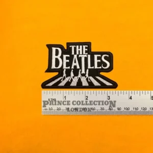 Alternative embroidered Beatles design beside measurement ruler