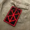 Embroidered dark fantasy symbol border and stitching detail