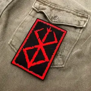 Embroidered dark fantasy symbol border and stitching detail