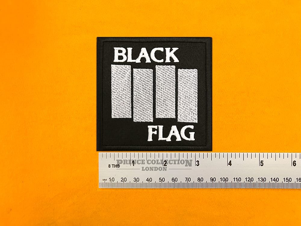 Embroidered Black Flag band design beside measurement ruler