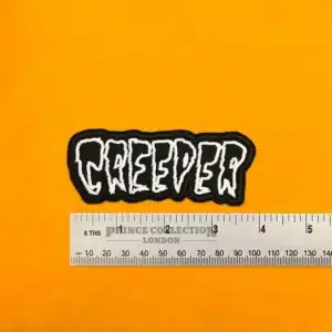 Embroidered Creeper logo beside measurement ruler
