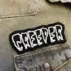 Black embroidered patch border and stitching detail