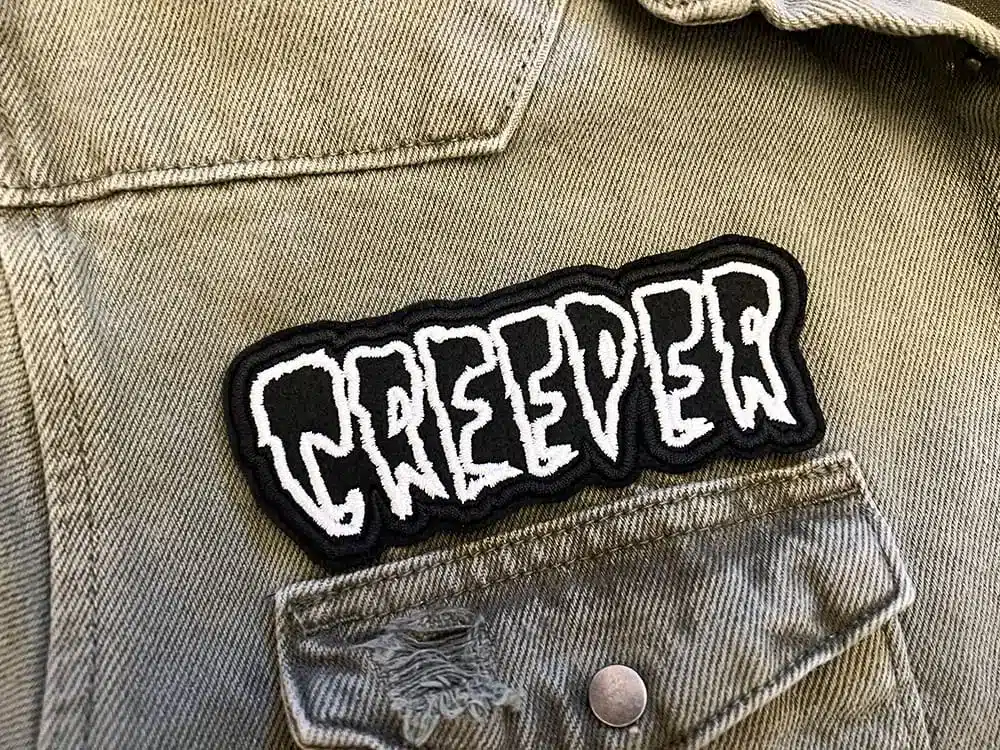 Black embroidered patch border and stitching detail
