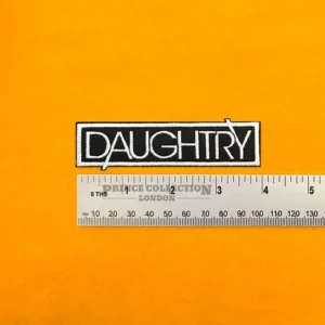 Embroidered band logo beside measurement ruler