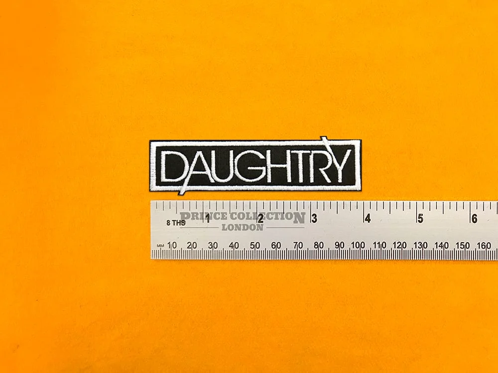 Embroidered band logo beside measurement ruler