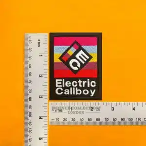 Embroidered Electric Callboy band design beside measurement ruler
