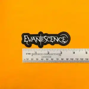Embroidered Evanescence band design beside measurement ruler