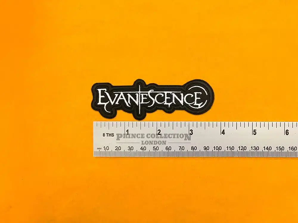 Embroidered Evanescence band design beside measurement ruler
