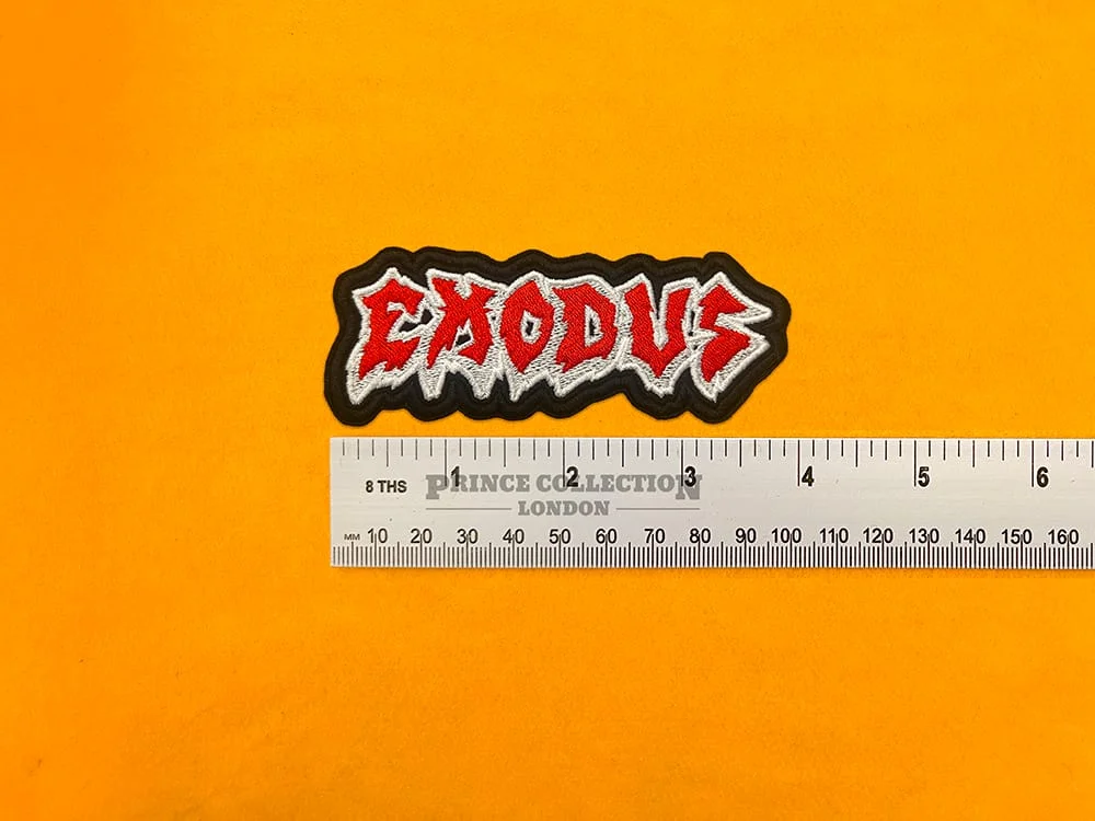 Embroidered Exodus band design beside measurement ruler