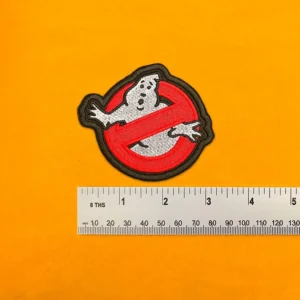 Embroidered Ghostbusters design beside measurement ruler