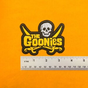 Embroidered Goonies design beside measurement ruler