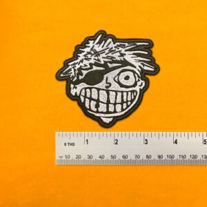 Embroidered Green Day design beside measurement ruler
