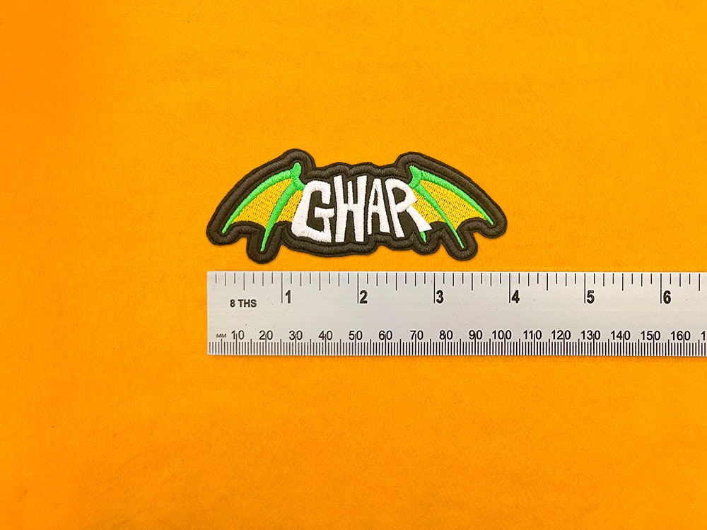 GWAR embroidered band patch beside measurement ruler