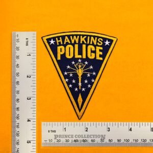 Embroidered Hawkins Police design beside measurement ruler