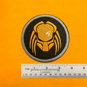 Embroidered Predator film design beside measurement ruler