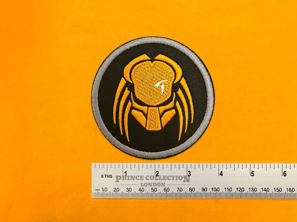 Embroidered Predator film design beside measurement ruler