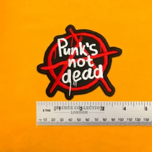 Punks Not Dead slogan patch beside measurement ruler