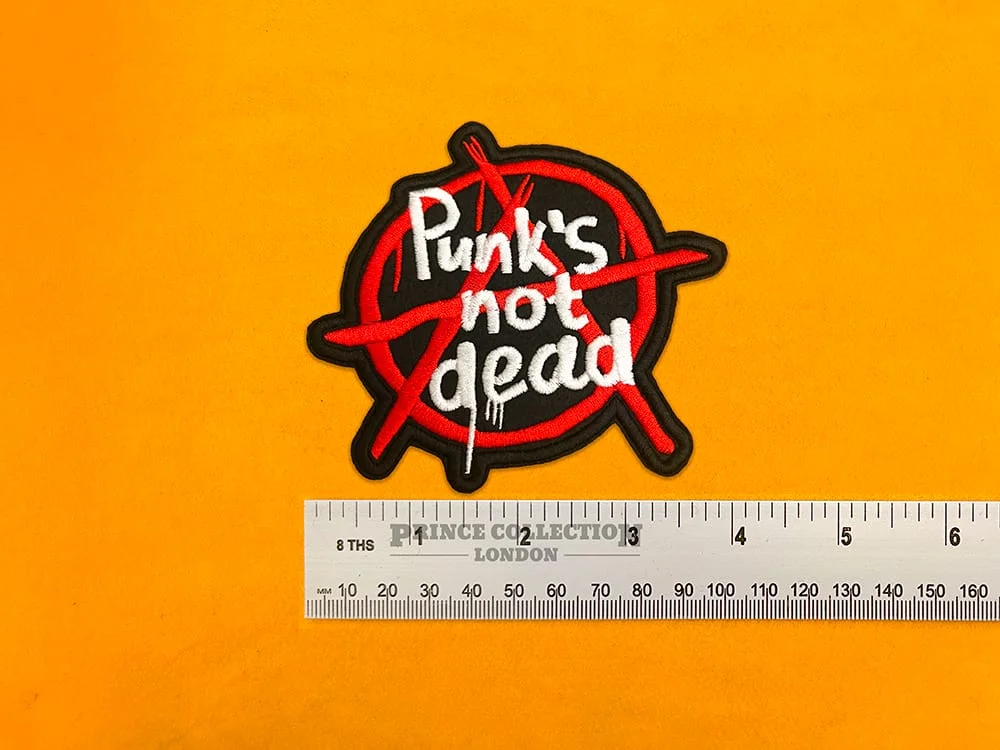 Punks Not Dead slogan patch beside measurement ruler