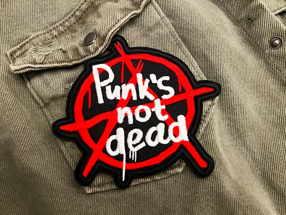 Embroidered punk slogan patch border and stitching detail