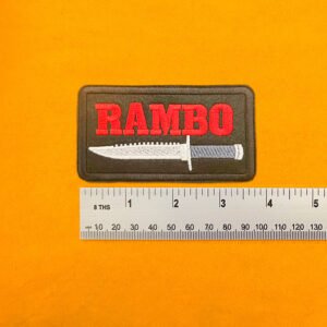 Embroidered Rambo design beside measurement ruler