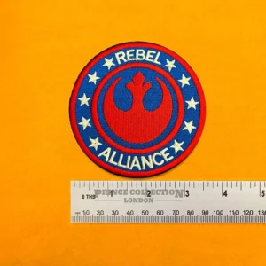 Embroidered Rebel Alliance symbol beside measurement ruler