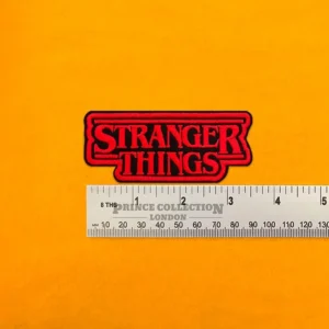 Embroidered Stranger Things design beside measurement ruler