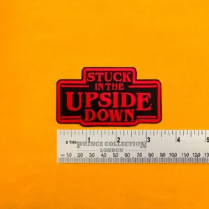 Embroidered Upside Down design beside measurement ruler
