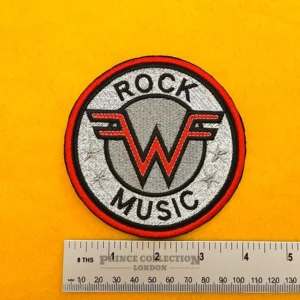 Weezer embroidered band patch beside measurement ruler