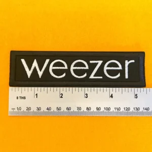 Embroidered Weezer patch dimensions beside ruler