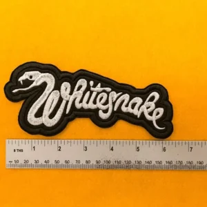 Whitesnake embroidered band patch beside measurement ruler