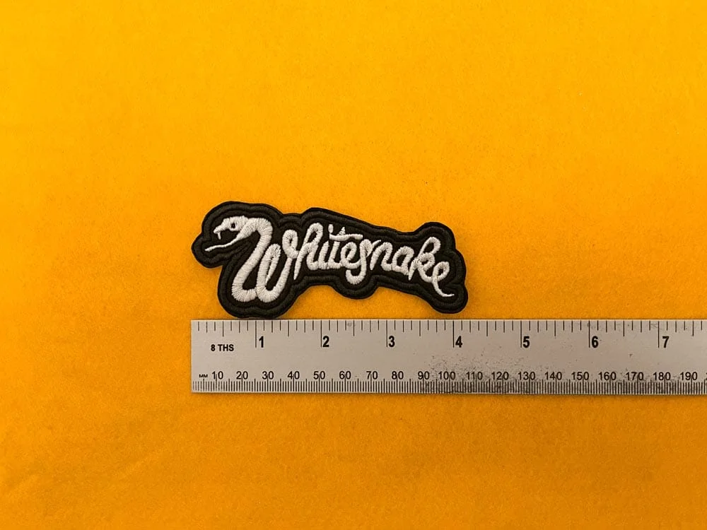 Embroidered Whitesnake patch dimensions beside ruler