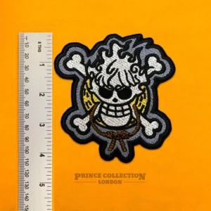 One Piece Luffy skull design beside measurement ruler