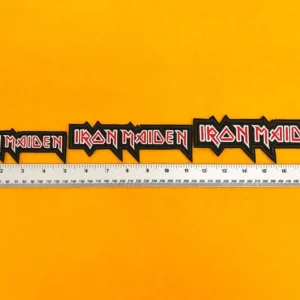 Embroidered Iron Maiden logo beside measurement ruler