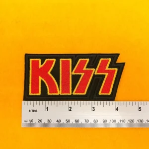 Embroidered KISS logo beside measurement ruler