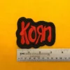 Embroidered Korn design beside measurement ruler