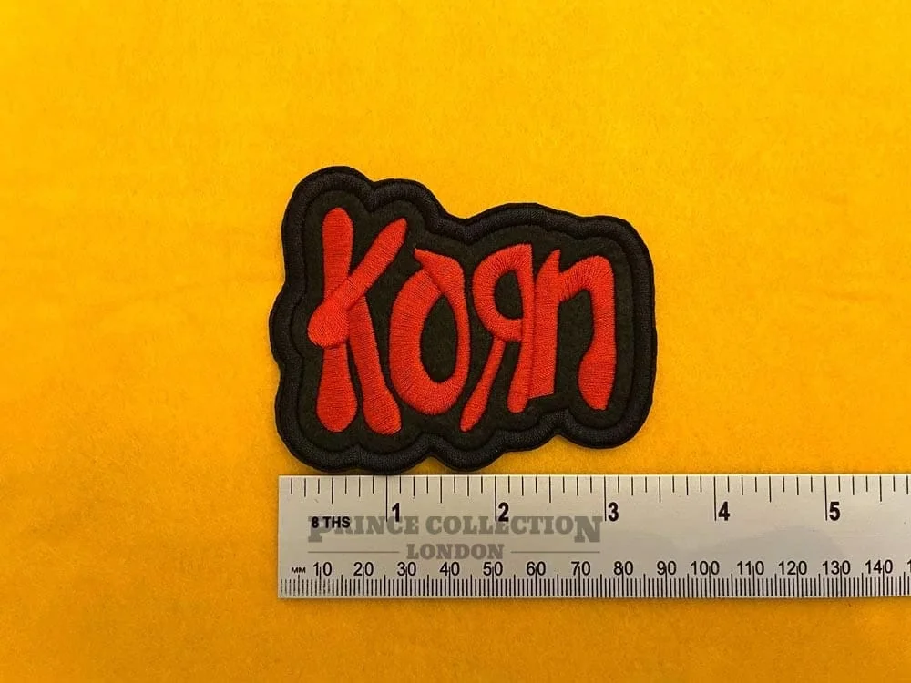 Embroidered Korn design beside measurement ruler