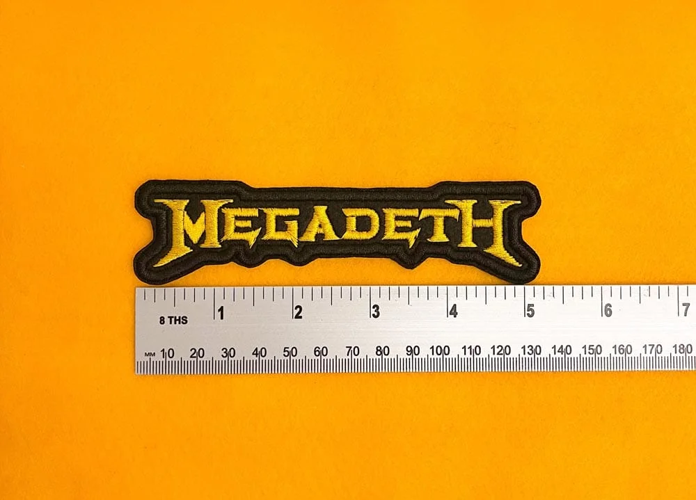 Embroidered Megadeth design beside measurement ruler