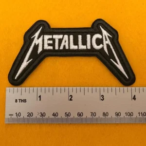 Embroidered Metallica design beside measurement ruler