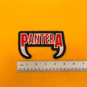 Embroidered Pantera design beside measurement ruler