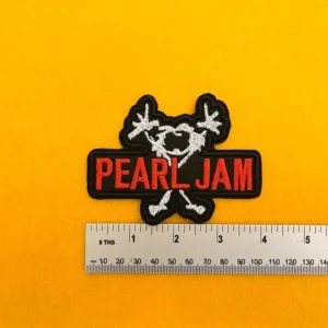 Embroidered Pearl Jam design beside measurement ruler