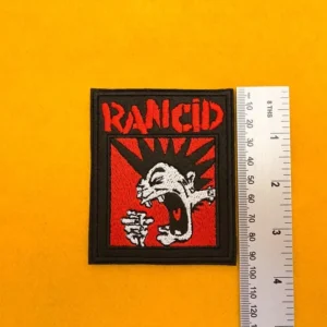 Embroidered Rancid design beside measurement ruler
