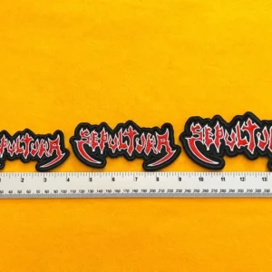Embroidered Sepultura design beside measurement ruler