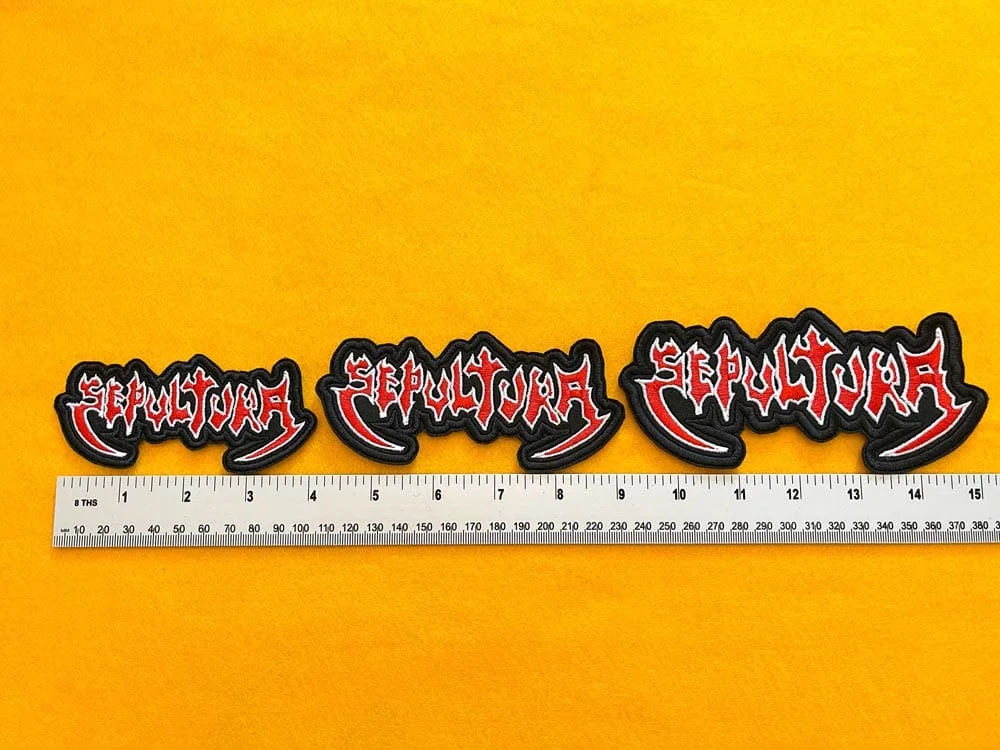 Embroidered Sepultura design beside measurement ruler