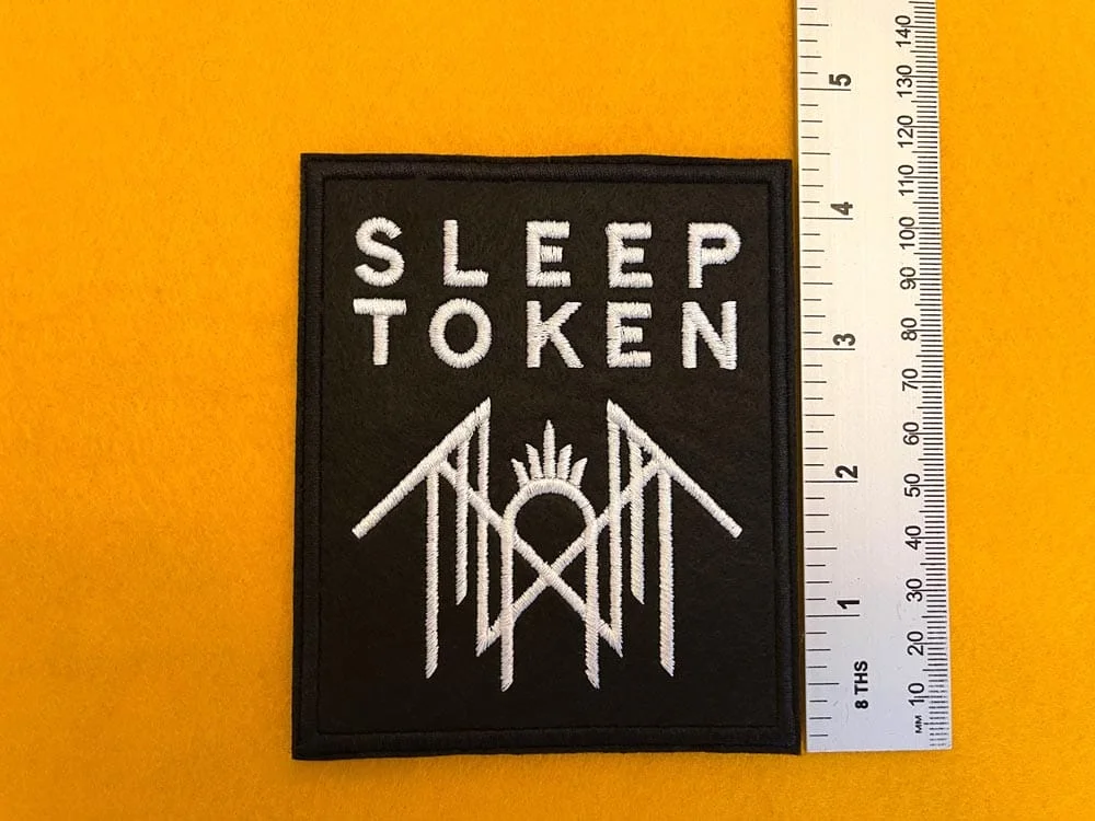 Embroidered Sleep Token design beside measurement ruler