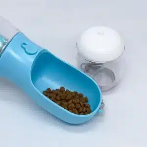 Dog travel water bottle with integrated poop bag holder