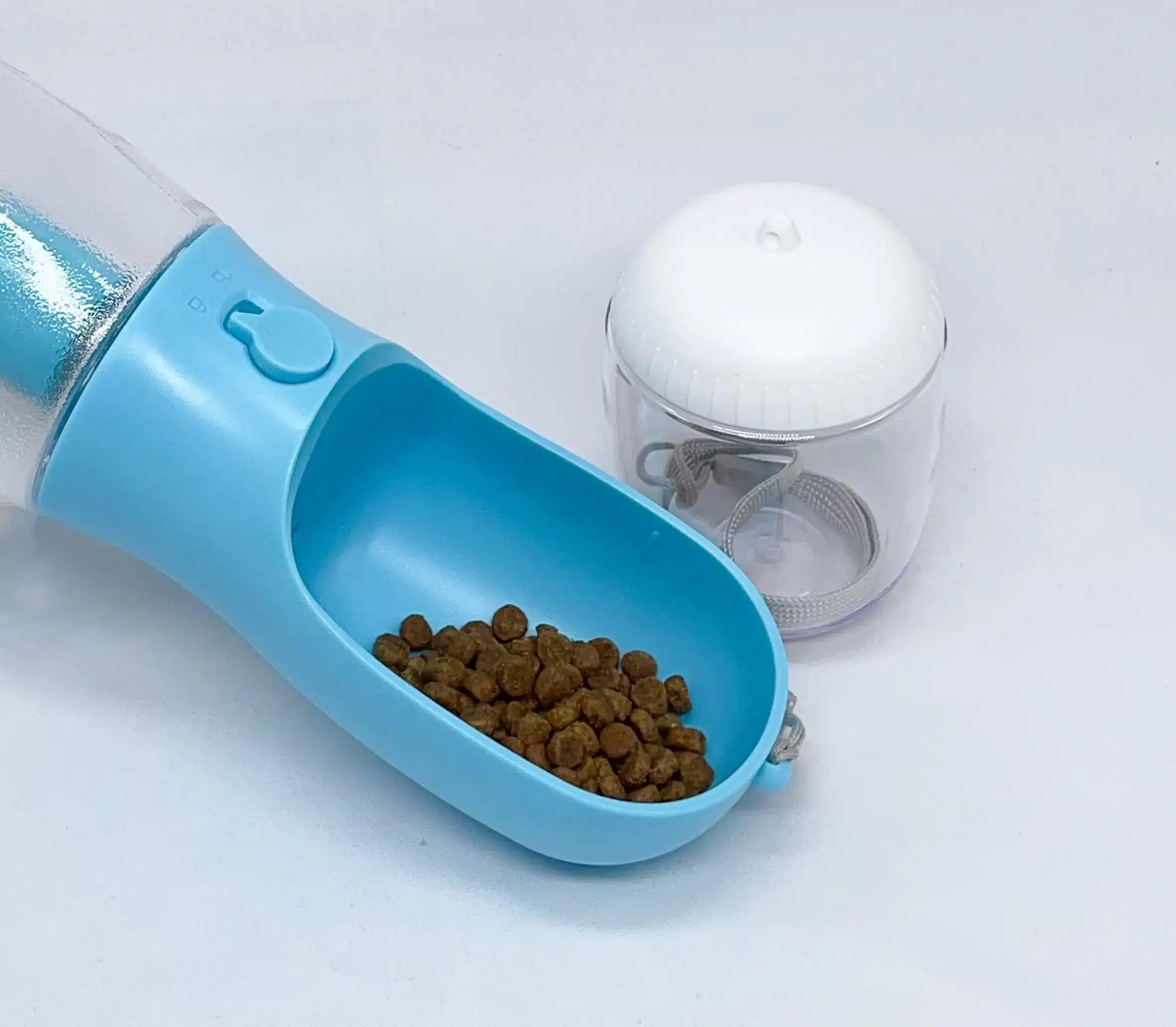 Dog travel water bottle with integrated poop bag holder